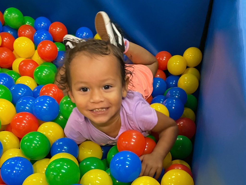 A child at play in a children's ball pit