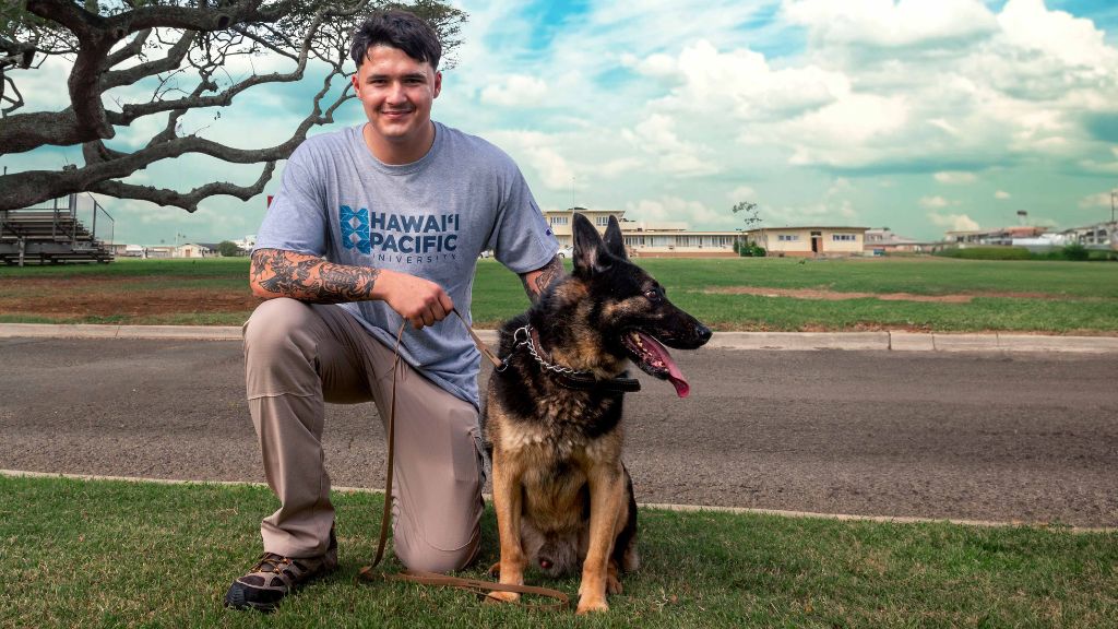 Caden Villegas, a military police officer dog handler, and his dog, at Marine Corps Base Hawaiʻi in Kaneohe