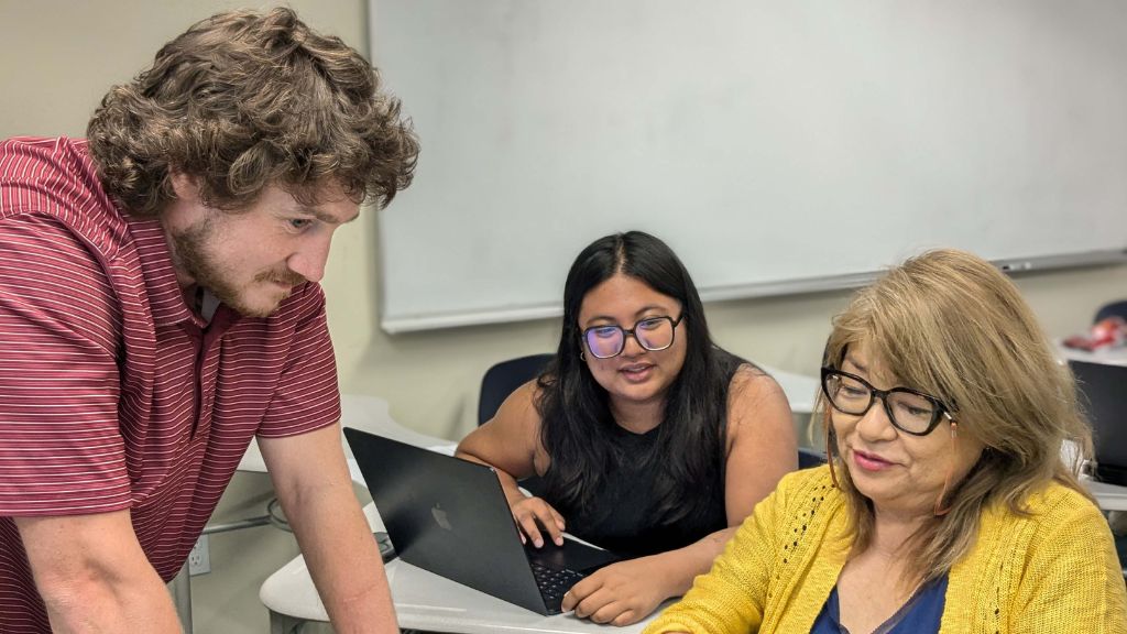 Keegan Jones, Kylie Asuncion, and Miki Davidson compare notes as they edit biographical sketches for their high school authors