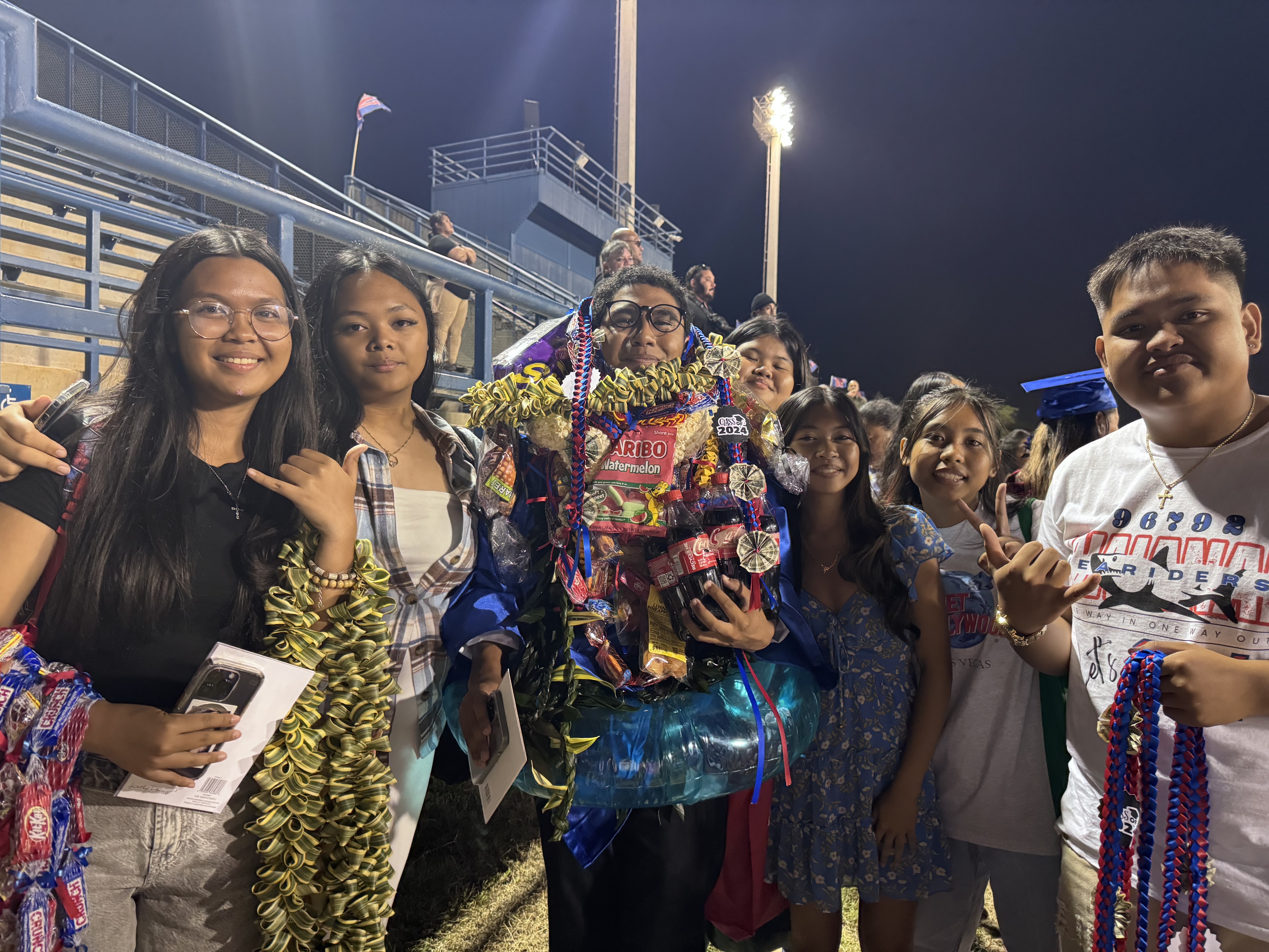 HPU Ho'oko Rising Scholars student Kaena Agabin (center, with lei) is a psychology major