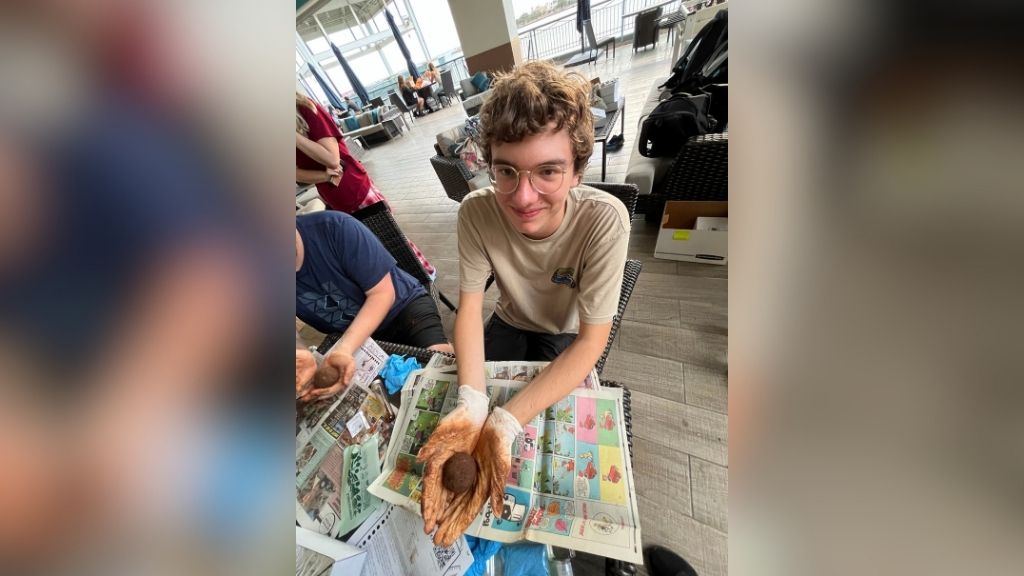 An HPU student at a Genki ball-making workshop hosted by Nā Manō 'o Ke Kai at Sharky's Cove,Aloha Tower Marketplace