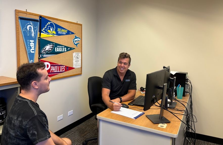 picture of librarian helping student in office